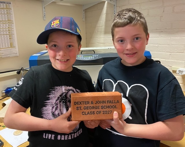 Dexter & John Falla show off their brick in support of the CTE/Makerspace Project